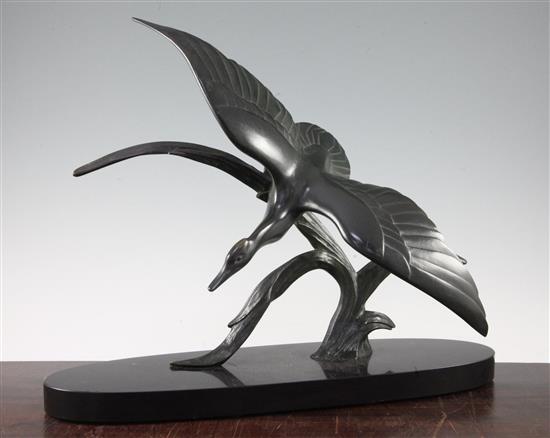 A French Art Deco patinated bronze model of a duck in flight, 14.5in.